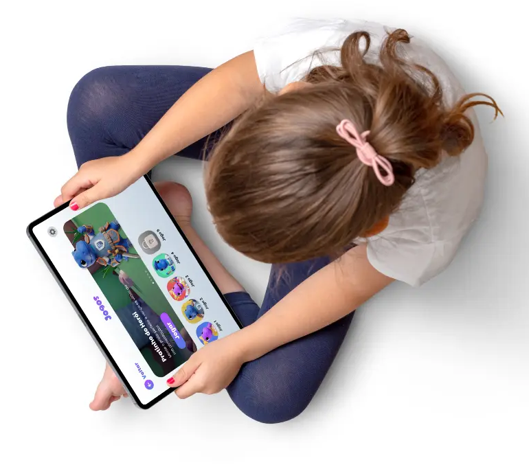 Criança sentada no chão segurando um tablet com a tela de jogos do app aberta